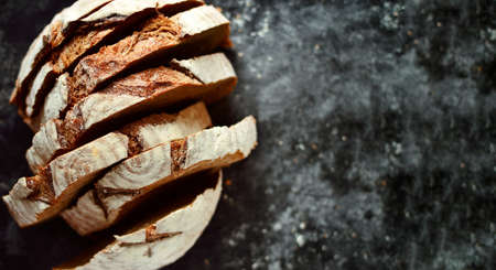 Bakery products. Crispy, beautiful bread on a dark background. Top view, copyspace. Bread background.の写真素材