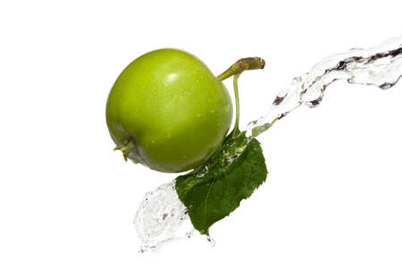green apple with a leaf in waterの写真素材