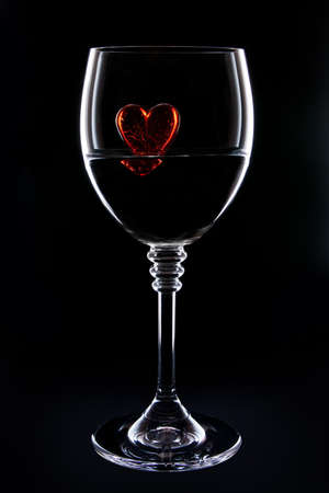 red glass heart in a glassの写真素材
