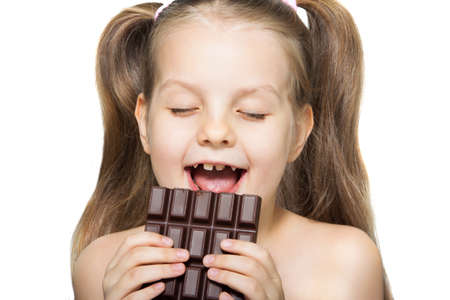 little girl eating chocolateの写真素材