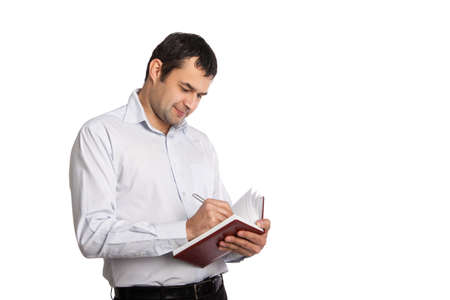 Happy Employee writes notes in notebookの写真素材