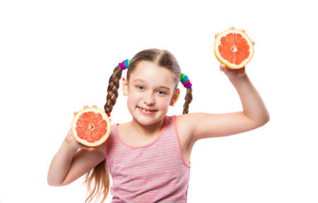 girl with a grapefruit on a white backgroundの写真素材