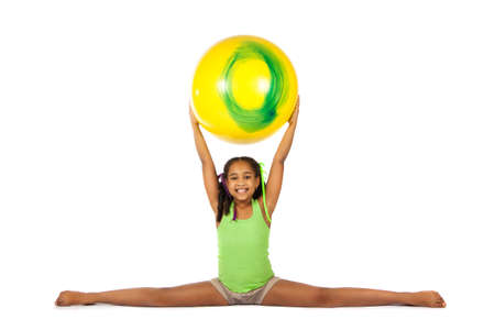 girl is engaged in gymnastics. child sitting on the splits. isolated on a white backgroundの写真素材