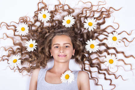 girl lying with flowers in her hairの写真素材