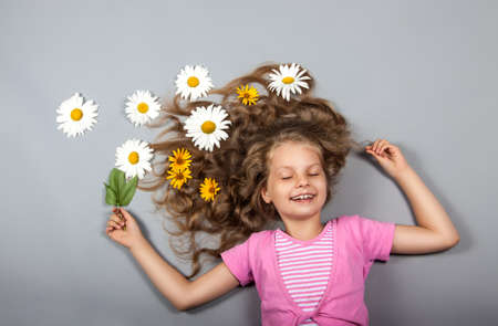 girl lying with flowers in her hairの写真素材