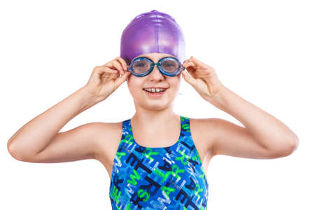 Portrait of a young girl in goggles and swimming cap. happy girlの写真素材