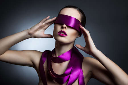 portrait of a girl with a purple ribbon in her eyesの写真素材