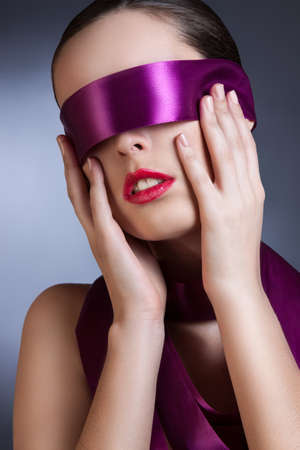 portrait of a girl with a purple ribbon in her eyesの写真素材