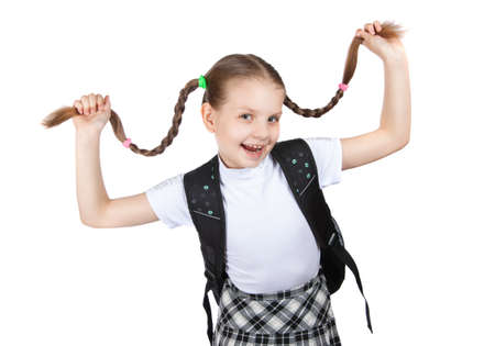 beautiful little girl in school uniform with books isolated on whiteの写真素材