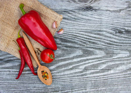 Red pepper and vegetables on wooden textureの写真素材