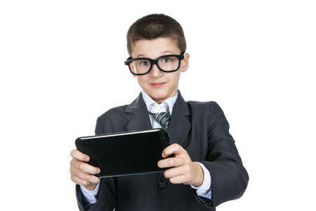 Shocked and surprised boy schoolboy wearing glasses. Smart boy with a tablet in hands. The concept of modern education. Isolation on a white backgroundの写真素材
