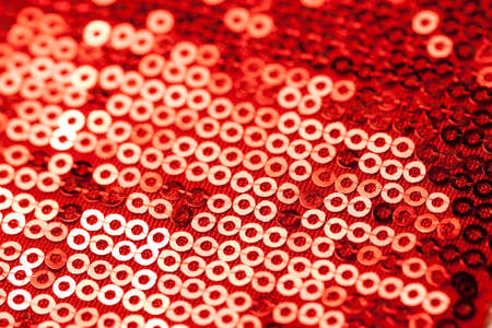Fabric with bright sequins for background. Closeup of fabric embroidered with sequins.の写真素材