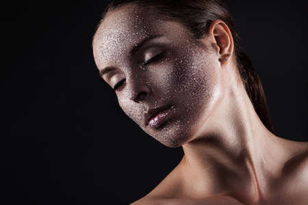 Beauty, fashion, make-up. Woman with glitter on her face. Beauty close-up portraitの写真素材