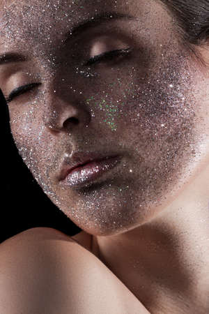 Beauty, fashion, make-up. Woman with glitter on her face. Beauty close-up portraitの写真素材