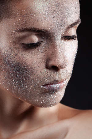 Beauty, fashion, make-up. Woman with glitter on her face. Beauty close-up portraitの写真素材