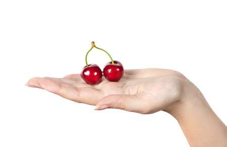 Berries cherries on woman's palm. Red berries on hand. Isolation on a white backgroundの写真素材