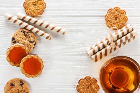 a variety of cookies and sweets on a white wooden table. horizontal view from aboveの写真素材
