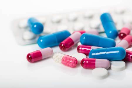 pile of medical pills and blue pills on background. close-up. macroの写真素材