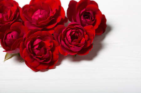 Red roses. Beautiful flowers on a white deoevian table. Empty space for textの写真素材