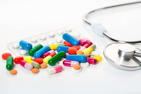 Lots of colorful drugs and pills. Pills in packages and the scattered multi-colored tablets and...