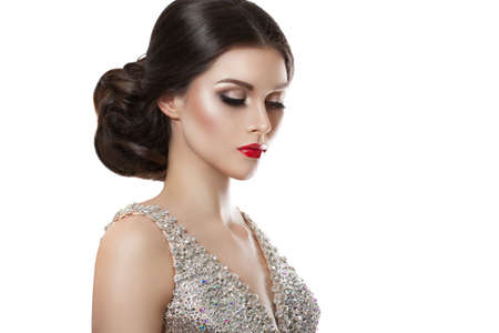 beauty fashion portrait of a beautiful model in an evening dress embroidered with stones. Isolation...