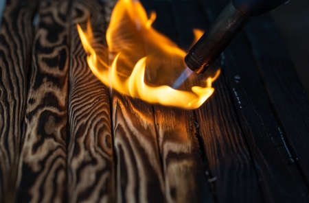 Charred wooden planks and fire.の写真素材
