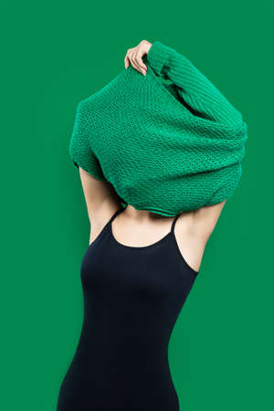 woman takes off her sweaterの写真素材