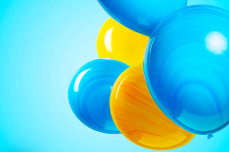 colorful balloons isolated on blue turquoise background. Birthday party, positive mood.の写真素材
