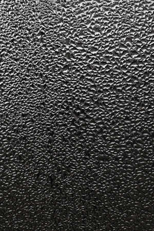 Monochrome abstraction blurry drops of water on the glass.の写真素材