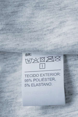 Clothing care label. Close-up tag on a knitwearの写真素材