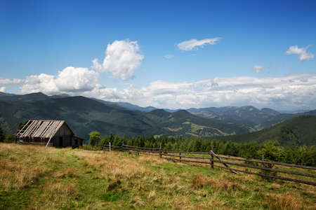 Beautiful mountain landscape. Old wooden house in the mountainsの写真素材