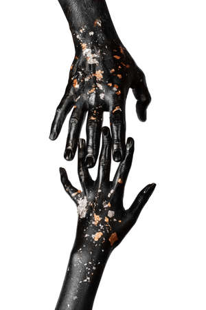 Black and gold hands touch. Concept. Contact.の写真素材