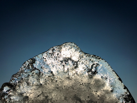 Abstract ice crystal formation against sun light and dark blue sky background with copy spaceの写真素材