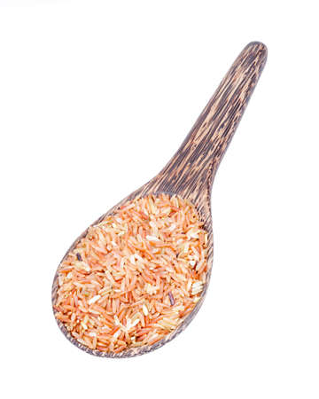 Organic Brown Rice (unpolished rice) on wooden ladle isolated on whiteの写真素材