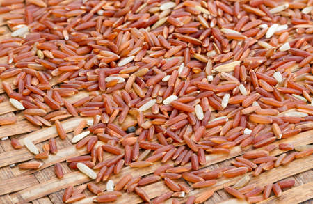 Organic Brown Rice (unpolished rice) on bamboo plateの写真素材