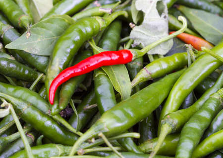 Red Cayenne pepper on pile of green Cayenne pepper