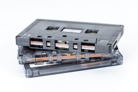 Retro Audio: A stack of vintage cassette tapes, relics of a bygone era, stand stacked atop each...