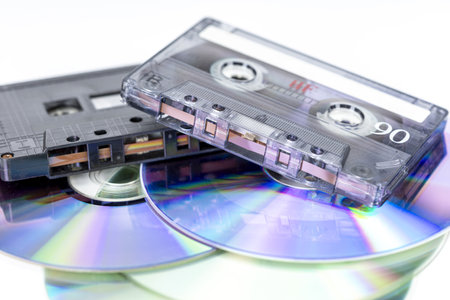 Retro Sounds of Time: A nostalgic collection of audio cassette tapes and compact discs, a vivid...