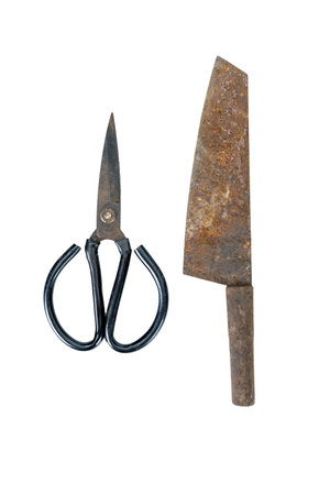 A rusty knife and metal scissors are placed side by side, showcasing their aged and worn appearance. knife has heavily corroded blade, while scissors have darkened, oxidized finishの写真素材