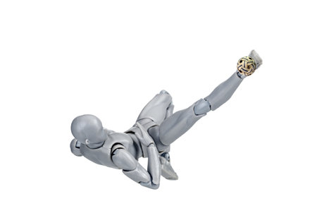 Attacker figurine performs dynamic sunback spike in sepak takraw, showcasing agility and balance. figure is mid air, emphasizing athleticism and motion against white backgroundの写真素材