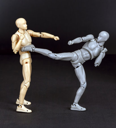 Attacker advances. Defender side-kicks with the right, unbalancing the attacker, then follows with a heel kick to chest or chin.の写真素材