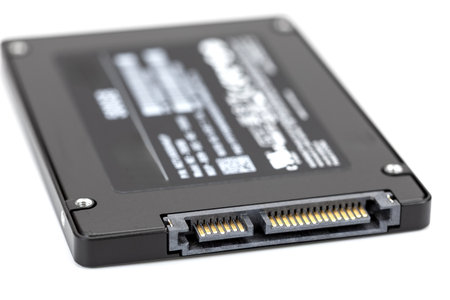 A close up image of black solid state drive ssd showcasing its connector pins and sleek design, highlighting modern technology used for data storageの写真素材