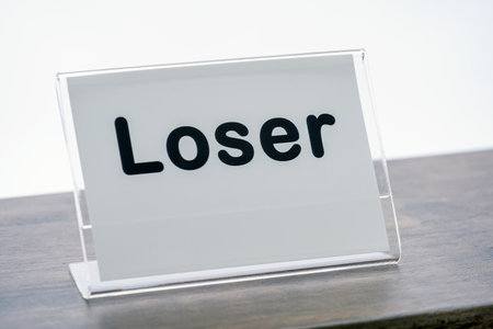A sign is displayed on wooden counter, conveying humorous or sarcastic message. sign is encased in...