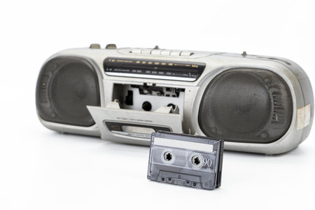 Vintage cassette player with open tape deck, classic retro audio equipment evoking nostalgic vibes, old technology isolated on white background.の写真素材