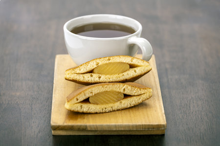 A tea pancake wooden board dessert sweet snack hot drink breakfast brown cup delicious cozy baked...