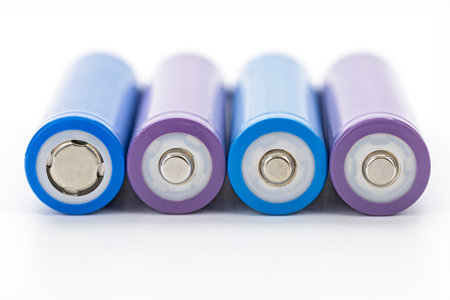 A closeup rechargeable batteries purple blue cylindrical shape metal terminal energy storage...