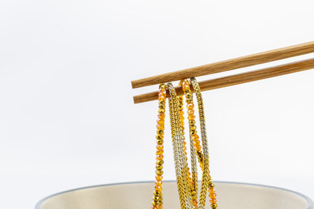 These stunning gold and amber beaded necklaces are beautifully suspended on bamboo chopsticks. The...