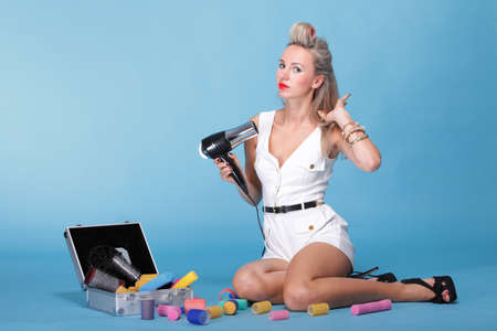 pin up girl retro style portrait woman drying hair with electric fan