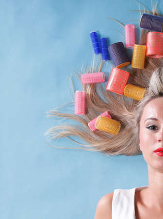 pin up girl retro style portrait woman drying hair with curl-papers hair curlers