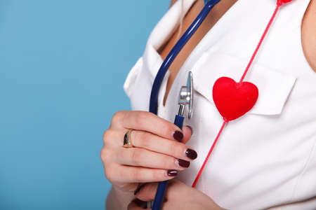 red heart woman in nurse suit with stethoscope blue backgroundの写真素材